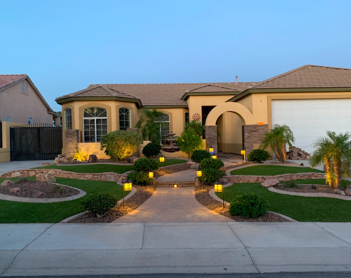 exterior view of a house with a beatiful landscape and paved entrance
